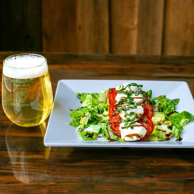 Caprese salad with fresh mozzarella, tomatoes, basil, and balsamic glaze at a Saratoga Springs restaurant