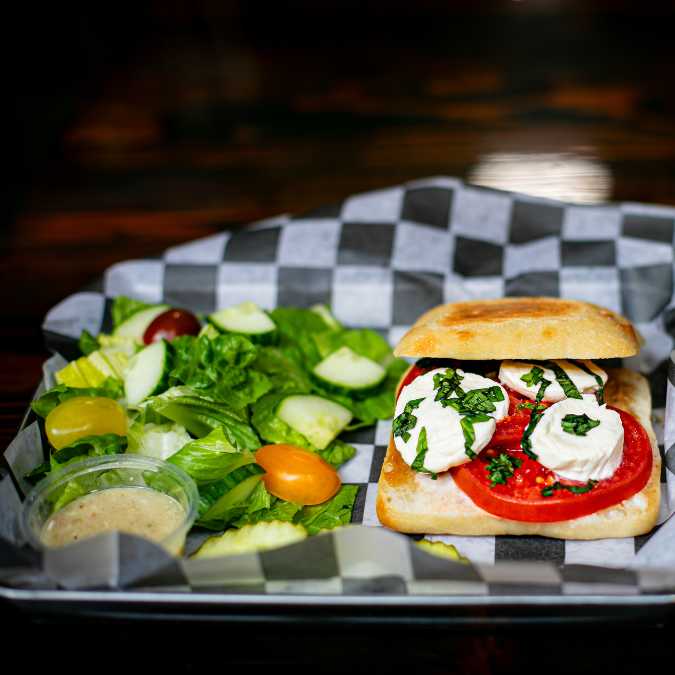 Caprese panini with fresh mozzarella, tomatoes, basil, and balsamic glaze at Nature’s Edge Bistro, a restaurant in Saratoga Springs