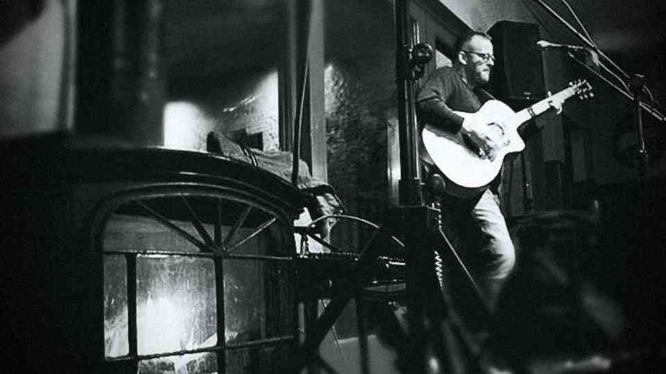 Pete Pashoukos playing guitar