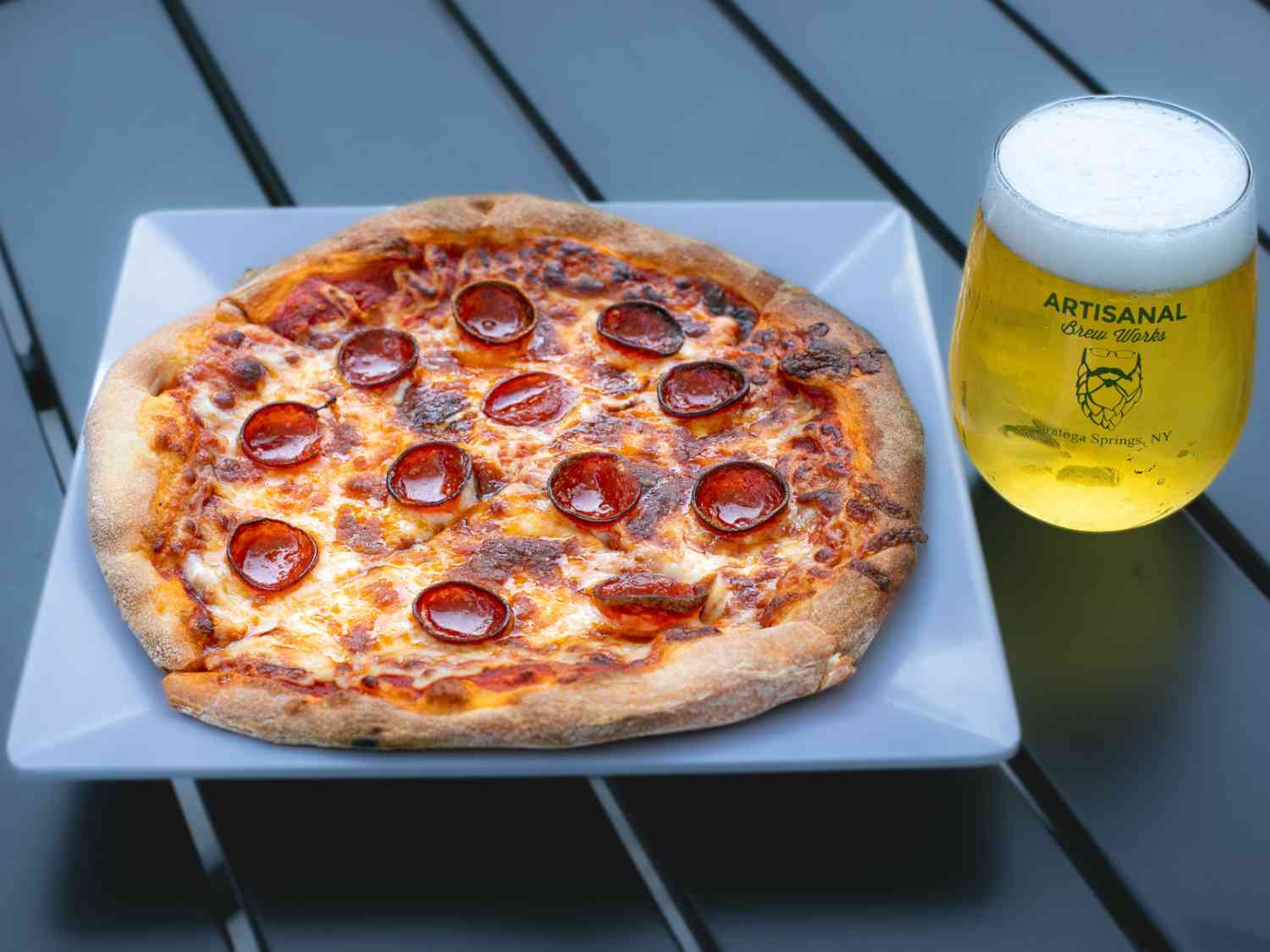 Pizza and a draft beer with cheese and pepperoni pizza at Nature’s Edge Bistro, a restaurant in Saratoga Springs