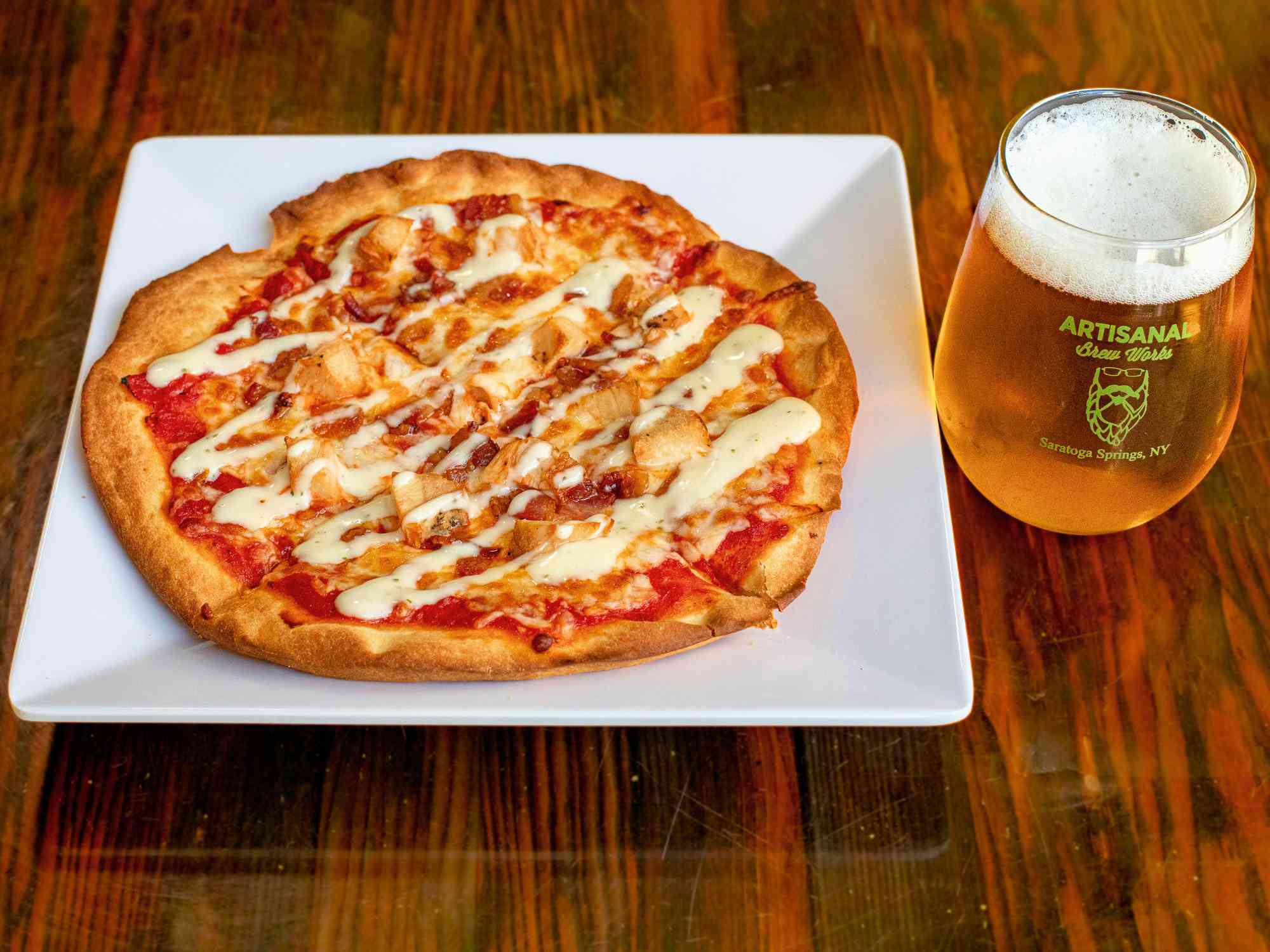 Chicken bacon ranch pizza with smoked bacon, chicken, and ranch dressing at a Saratoga Springs restaurant