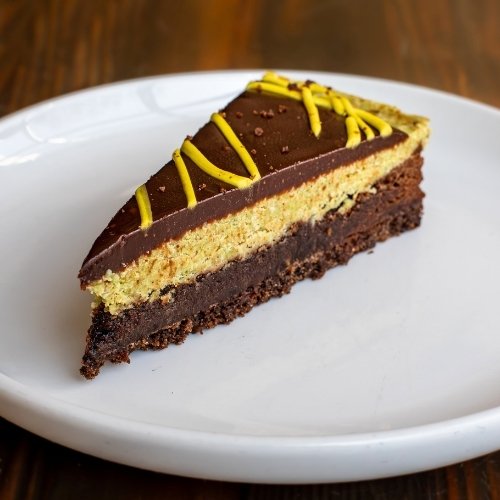 Dubai chocolate torte dessert with layered chocolate, pistachio, and ganache from the Artisanal Brew Works restaurant menu in Saratoga Springs