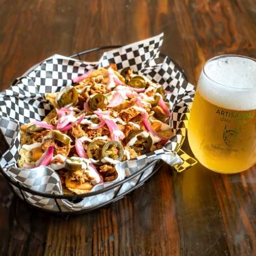 Tex Mex nachos with seasoned chicken, beer cheese, pickled onions, and jalapeños at Nature’s Edge Bistro, a restaurant in Saratoga Springs