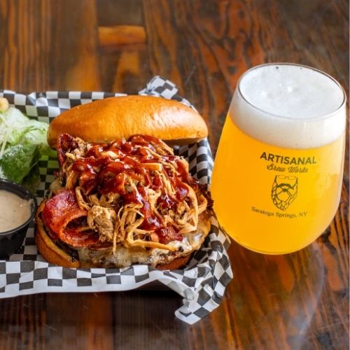Wagyu beef burger with pulled pork, ham, bacon, cheddar, and BBQ sauce at a Saratoga Springs restaurant