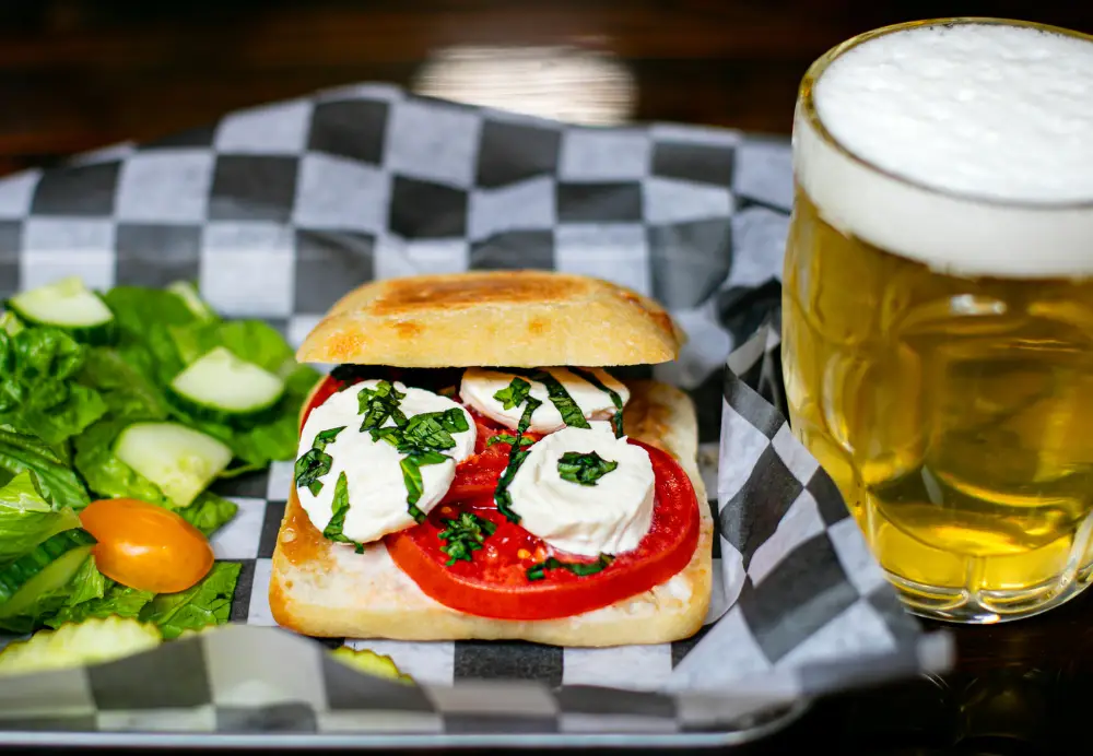 Caprese sandwich with fresh mozzarella, tomato and basil served with salad and beer at Nature’s Edge Bistro restaurant in Saratoga Springs