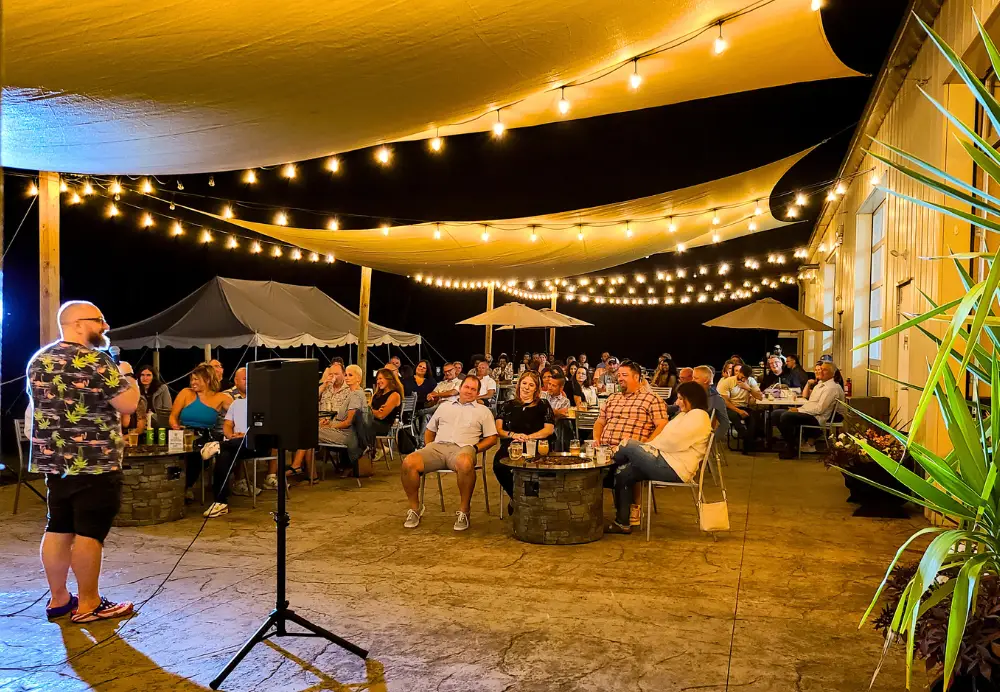 Outdoor dining at night with live entertainment on the Nature’s Edge Terrace at Artisanal Brew Works restaurant in Saratoga Springs