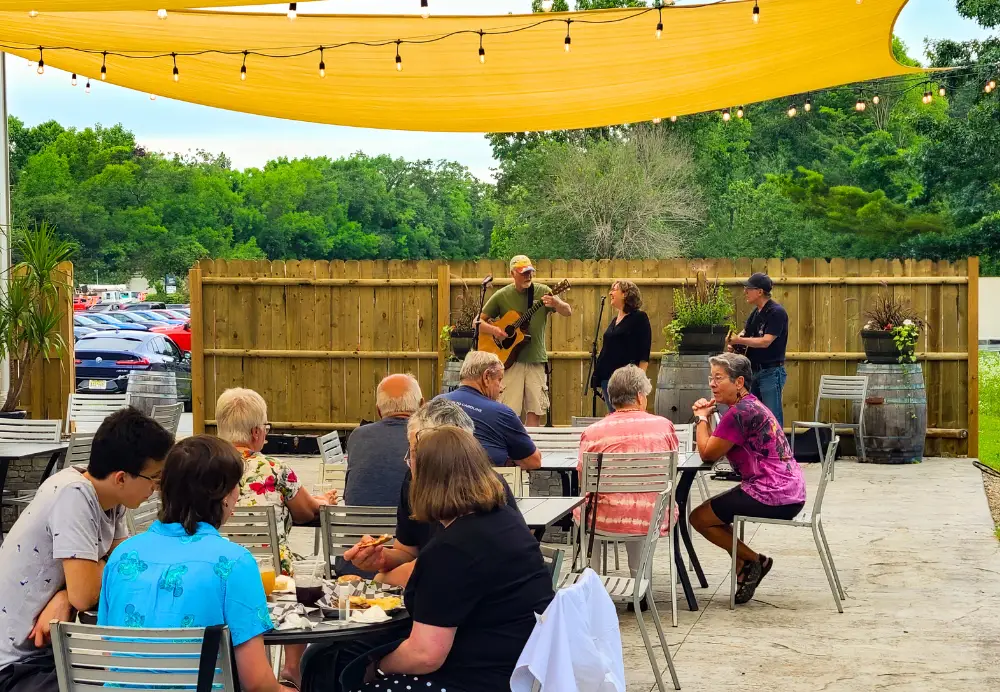 Outdoor dining with live music on the Nature’s Edge Terrace at Artisanal Brew Works restaurant in Saratoga Springs