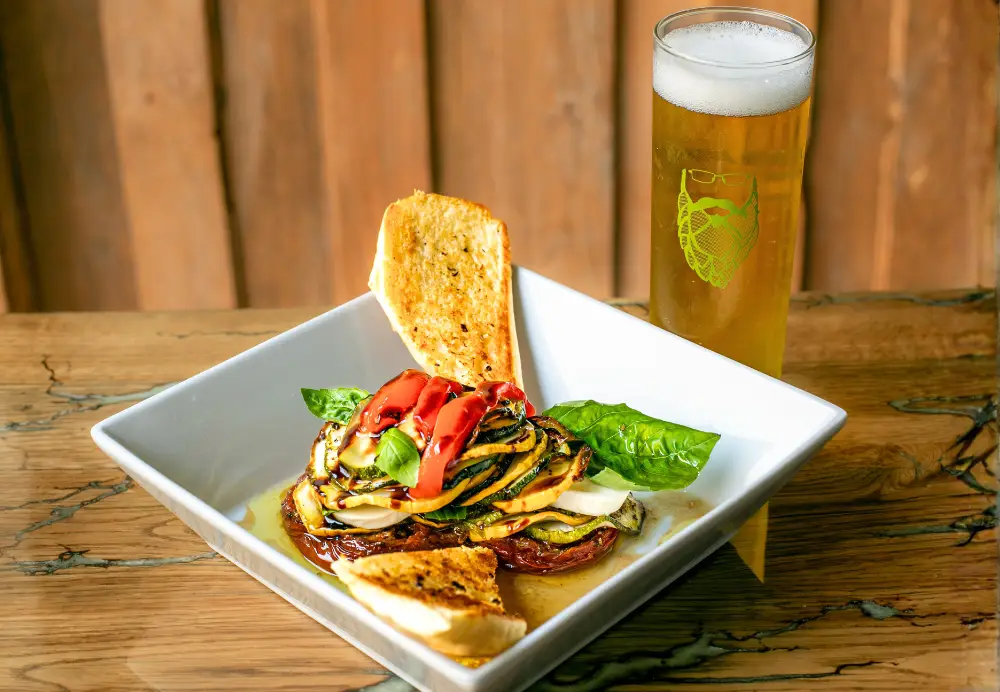 Vegetable napoleon salad with grilled zucchini, tomato, mozzarella and balsamic glaze at Nature’s Edge Bistro restaurant in Saratoga Springs